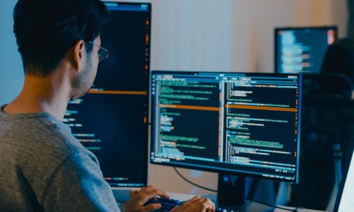 Group Adult Asia male, female freelance typing write prompt AI bot IT app smart program nomad, video game, terminal with coding language, designer, big data center on desktop computer in night office.